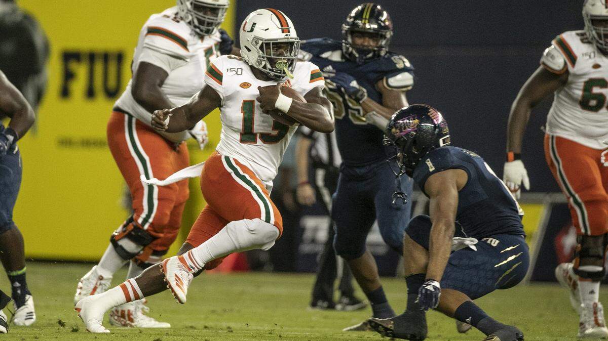 Miami Hurricanes running back DeeJay Dallas (13) runs for yardage in the first quarter as the Florida International University Panthers host the University of Miami Hurricanes at Marlins Park in Miami on Wednesday, November 23, 2019.