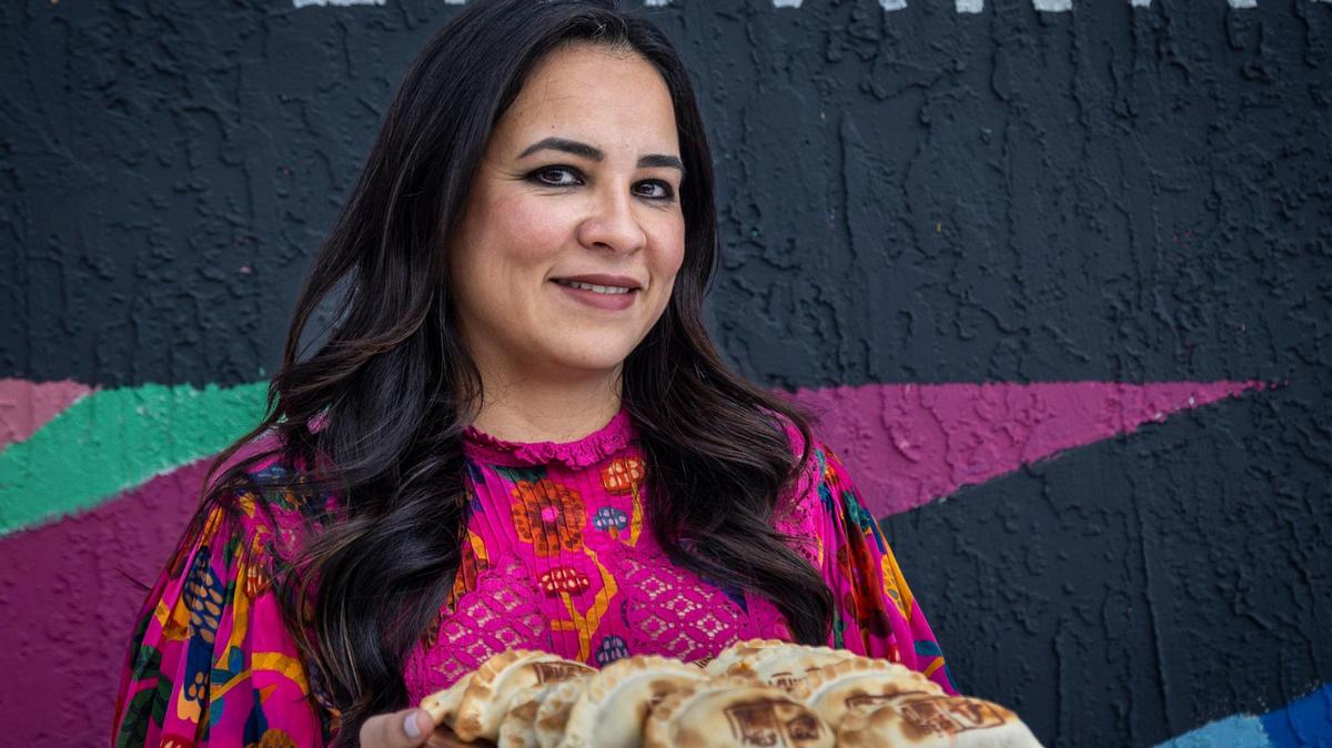 Pilar Guzman Zavala serves a tray of empanadas at Half Moon Empanadas, 5201 NW 2nd Ave. in Miami.
