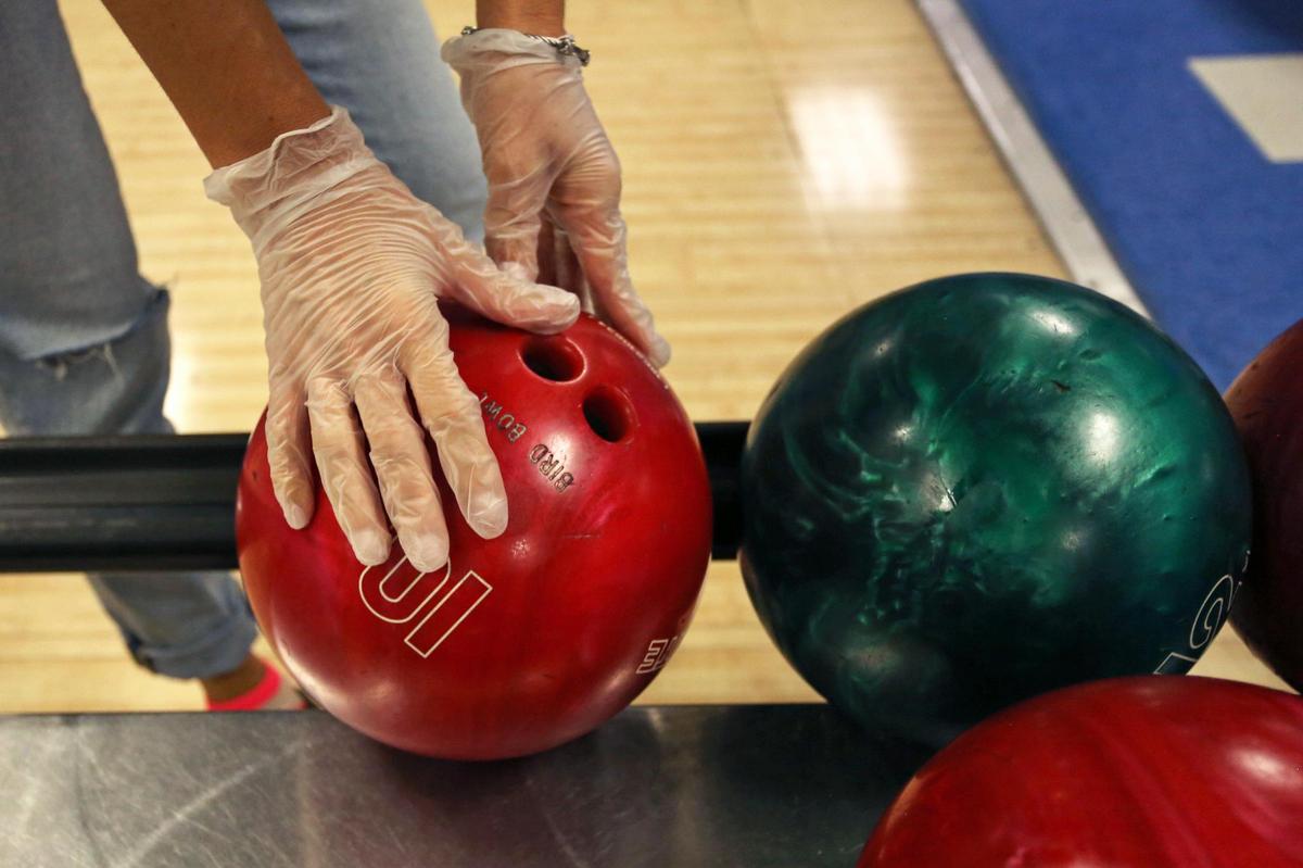 Melissa Cuadra, 41, wears gloves during a game at Bird Bowl Bowling Center on 9275 SW 40th St. in Westchester, Florida, as Miami-Dade County enters Phase 2 of reopening, Saturday, September 19, 2020.