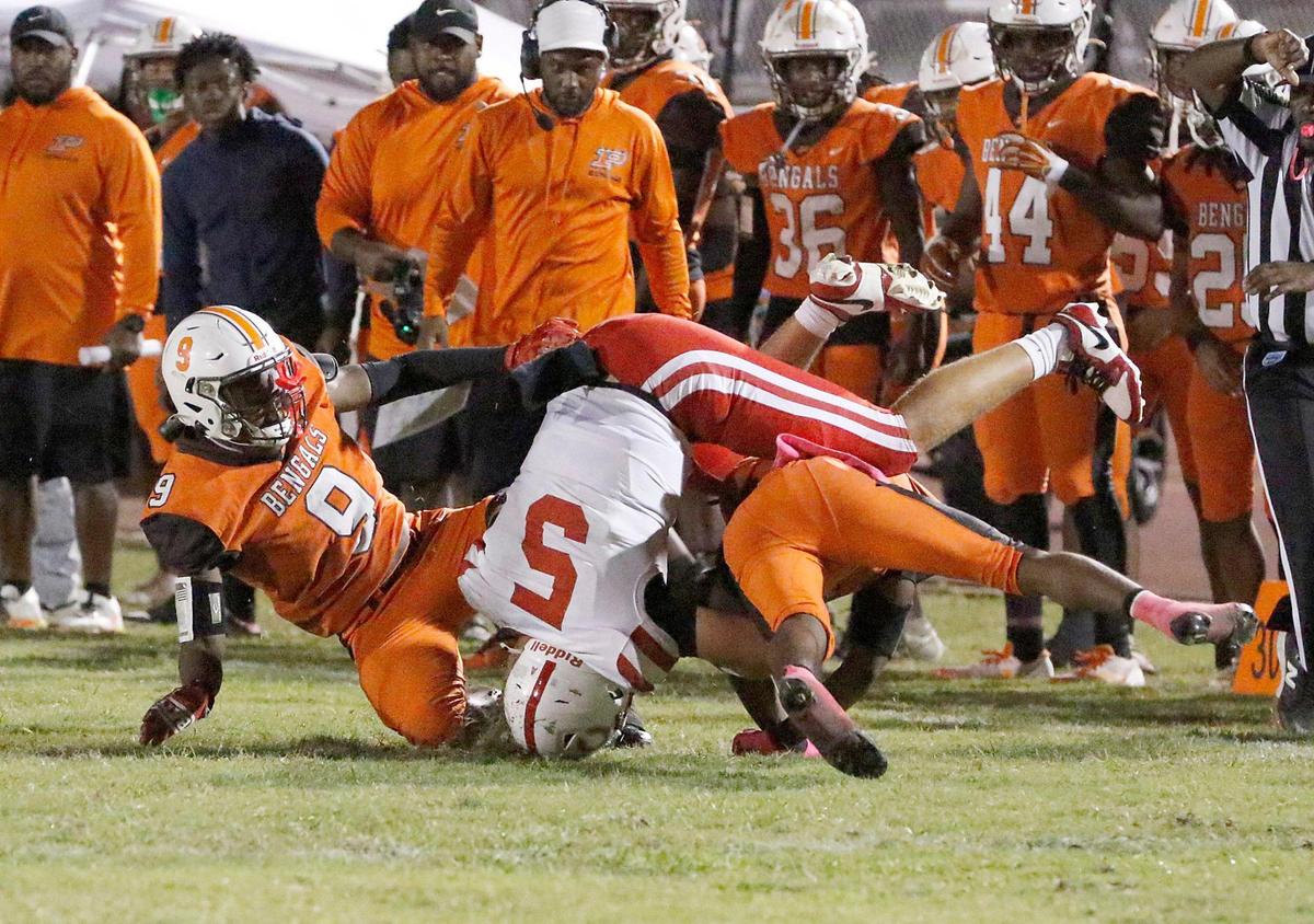 Piper Bengals defenders take down Plantation Colonels quarterback Jaden Chico (5) during football game on Friday, October 18, 2024 at Piper HS in Sunrise. Andrew Uloza / for Miami Herald