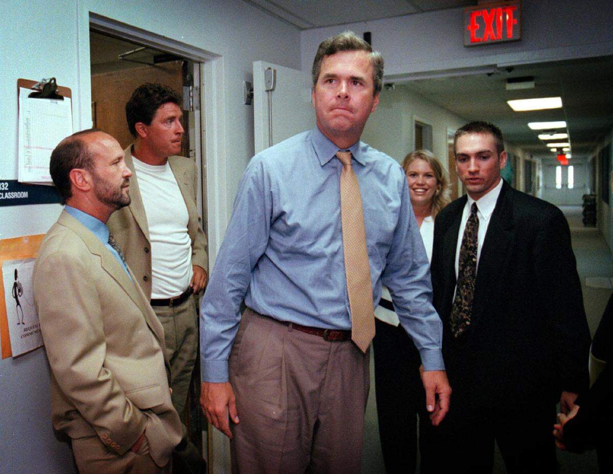 Ron Book, Dolphins quarterback Dan Marino (second from left), and then-gubernatorial candidate Jeb Bush take a tour of the Baudhuin School for Autism at Nova Southeastern University on July 21, 1998.