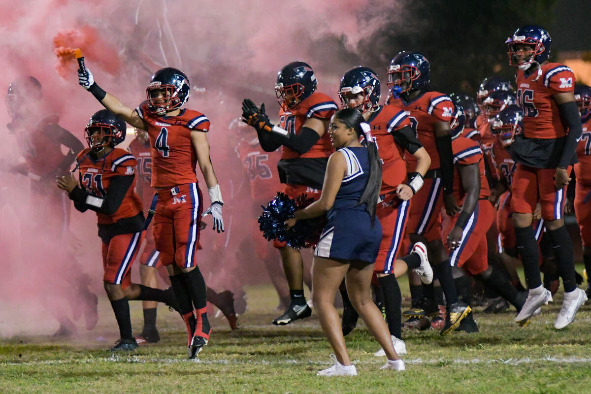 The Miramar football team runs onto the field before its playoff game against Southridge on Friday, Nov. 18, 2022.
