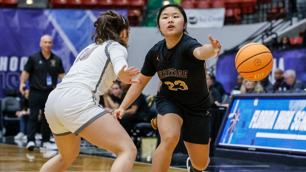 American Heritage’s Yinuo Wang (23) passes the ball as Palm Bay’s Gaby Buigues (10) defends in the first half of the FHSAA Class 4A Girls High School Basketball State Championship