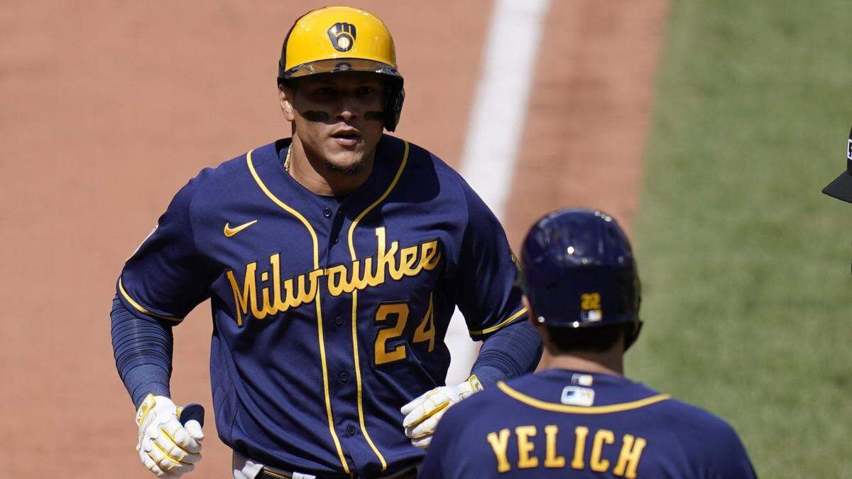 Milwaukee Brewers’ Avisail Garcia (24) is congratulated by teammate Christian Yelich (22) after hitting a two-run home run during the fifth inning of a baseball game against the St. Louis Cardinals Saturday, April 10, 2021, in St. Louis.