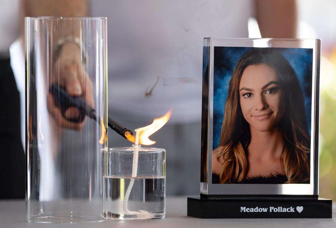 A candle is lit in honor of Meadow Pollack during the ‘Forever in Our Hearts’ commemoration event outside of the Eagles’ Haven Wellness Center on Friday, Feb. 14, 2025, in Coral Springs, Fla. The event aims to honor the 17 lives lost during the Marjory Stoneman Douglas High School shooting in 2018 and their families.