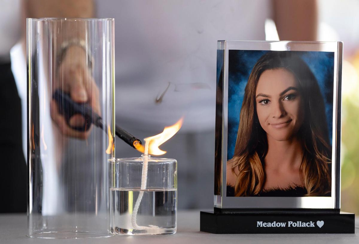 A candle is lit in honor of Meadow Pollack during the ‘Forever in Our Hearts’ commemoration event outside of the Eagles’ Haven Wellness Center on Friday, Feb. 14, 2025, in Coral Springs, Fla. The event aims to honor the 17 lives lost during the Marjory Stoneman Douglas High School shooting in 2018 and their families.