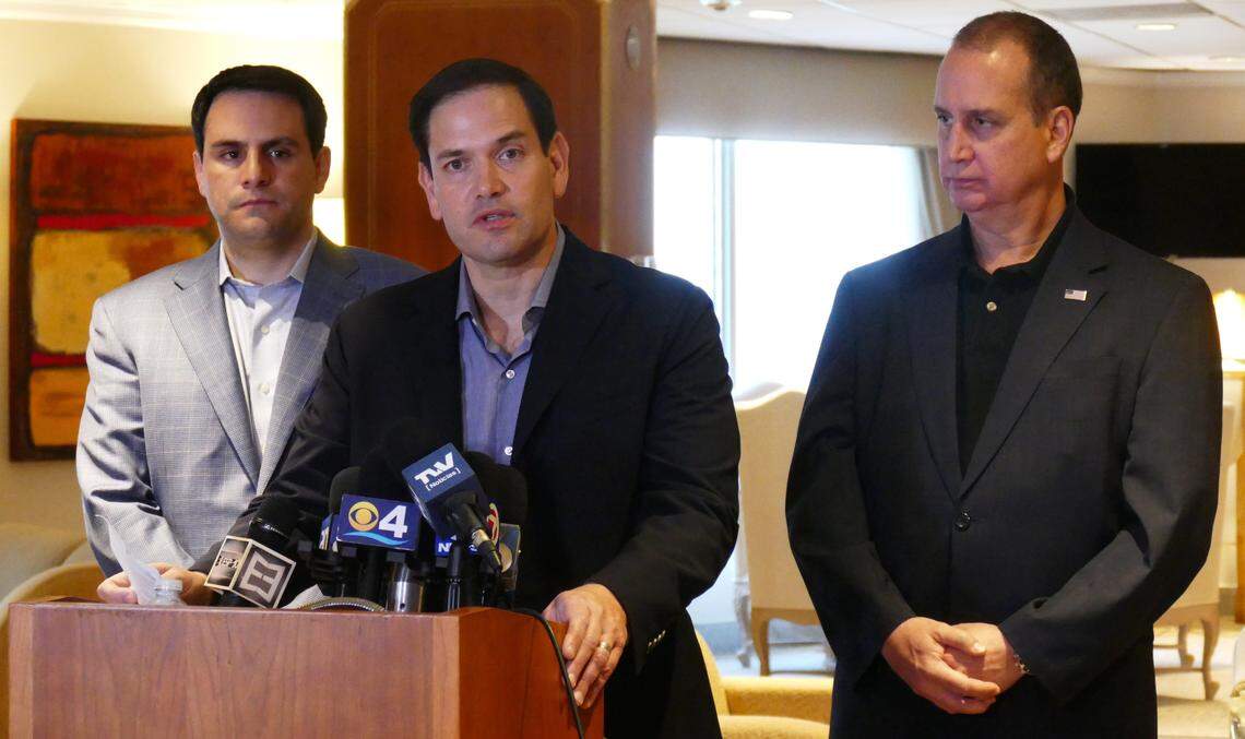 Following an official trip to the Colombia-Venezuela border, U.S. Sen. Marco Rubio speaks to the press as ambassador to the OAS Carlos Trujillo, left, and U.S. Rep. Mario Diaz-Balart, R-Fla., accompany him during a press conference at Miami International Airport on Feb. 18, 2019.