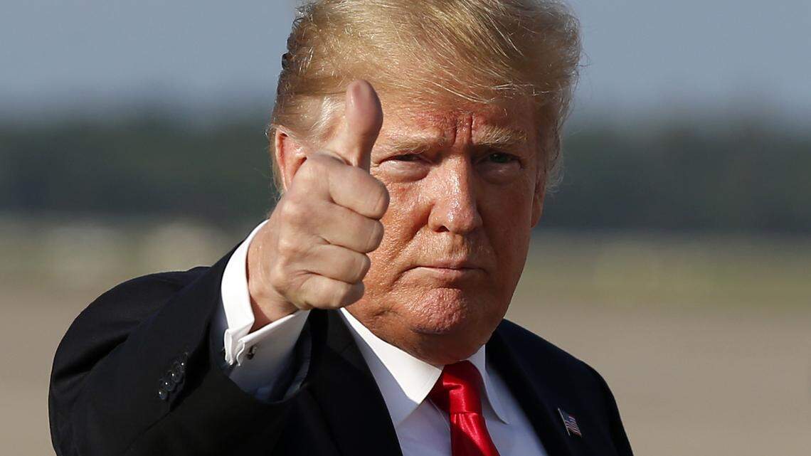 President Donald Trump gives thumbs up as he steps off Air Force One 