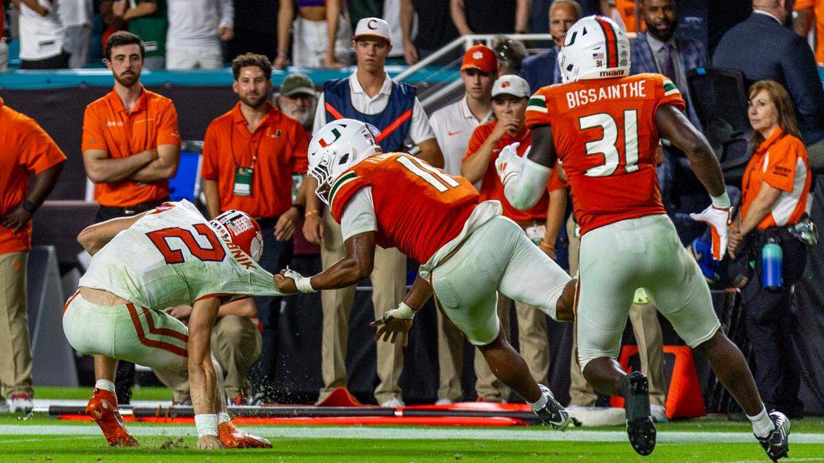 University of Miami linebacker Corey Flagg, Jr. (11) tackles  Clemson University quarterback Cade Klubnik (2) to win the game during the second overtime of an ACC college football game at Hard Rock Stadium in Miami Gardens, Florida, on Saturday, October 21, 2023.

