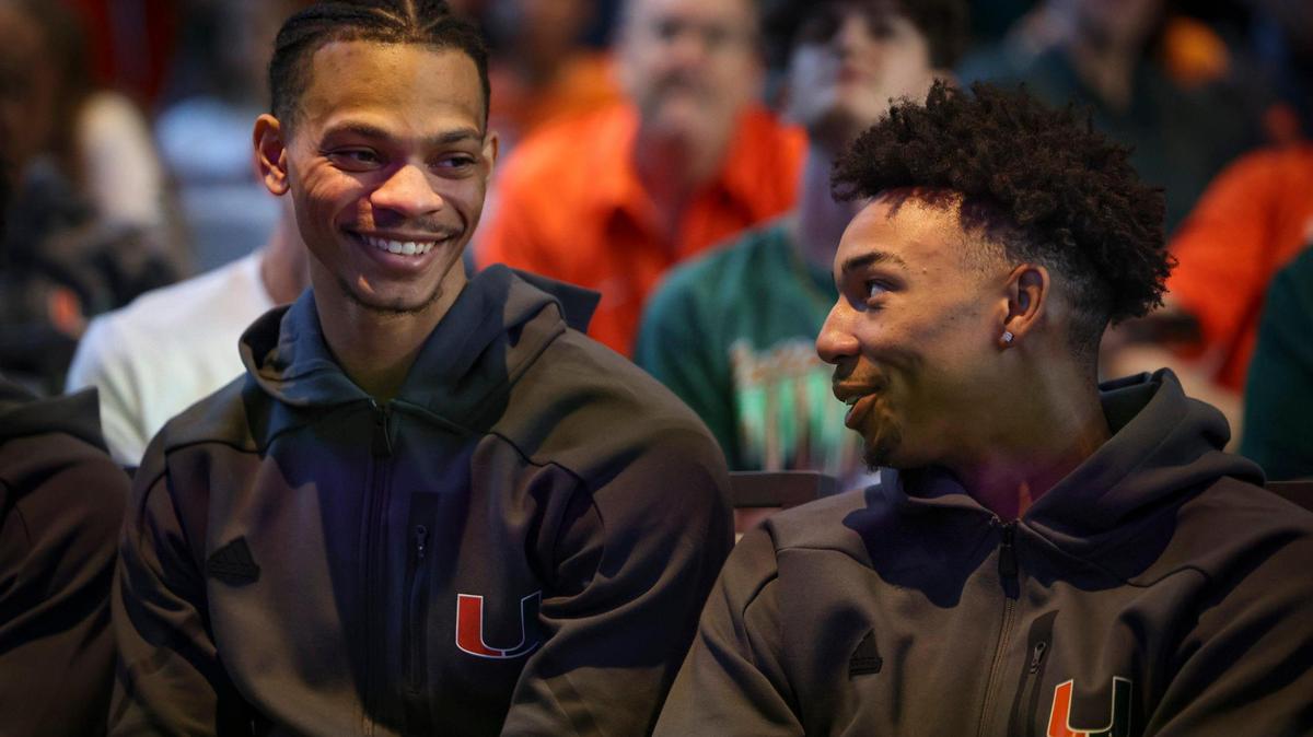 Isaiah Wong, left, talks to Jordan Miller during a watch party to decide where the Miami Hurricanes fall in the NCAA Tournament bracket on Sunday, March 12, 2023, in Coral Gables.