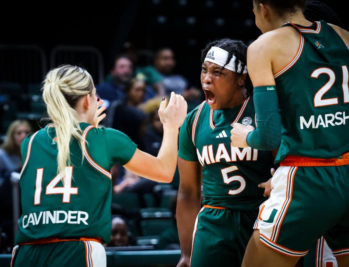 Miami Hurricanes Ahnay Adams(5) cheers with Haley Cavinder(14) after Adams scored a three pointer to finally take a lead during overtime of the game against the Quinnipiac Bobcats on Sunday, Dec. 1, 2024, at Watsco Center in Coral Gables, Fla. The Hurricanes won 83-74 in overtime.