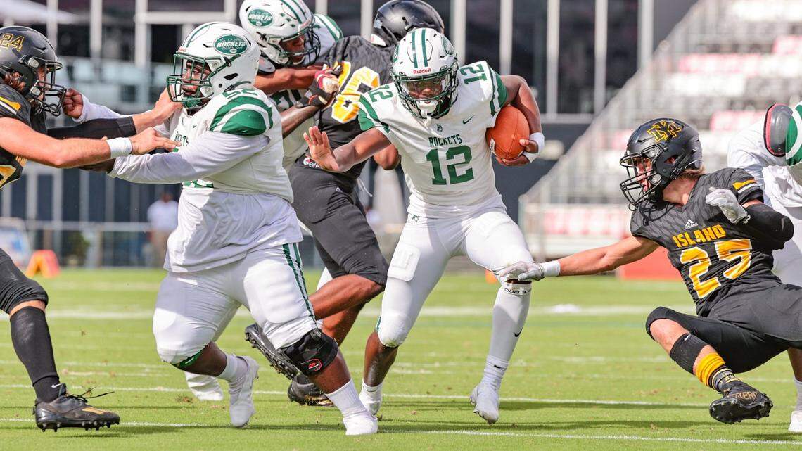 Miami Central High School quarterback Keyone Jenkins (12) breaks through the line of scrimmage to score in the second quarter against Merritt Island High School in the FHSAA Class 5A State Championship at DRV PNK Stadium, in Fort Lauderdale on Friday, December 17, 2021.