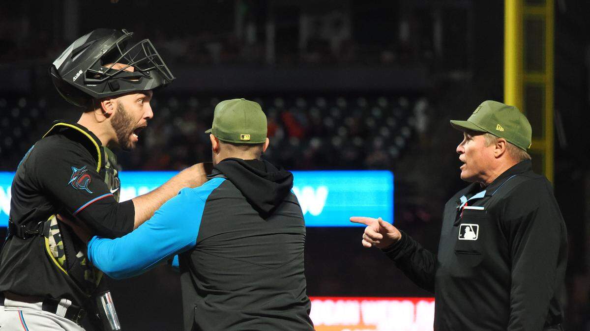 Miami Marlins catcher Jacob Stallings (58) is held back by manager Skip Schumaker (55) as he questions the call by home plate umpire Marvin Hudson (51) before being ejected during the eighth inning against the San Francisco Giants at Oracle Park on Friday, May 19, 2023.