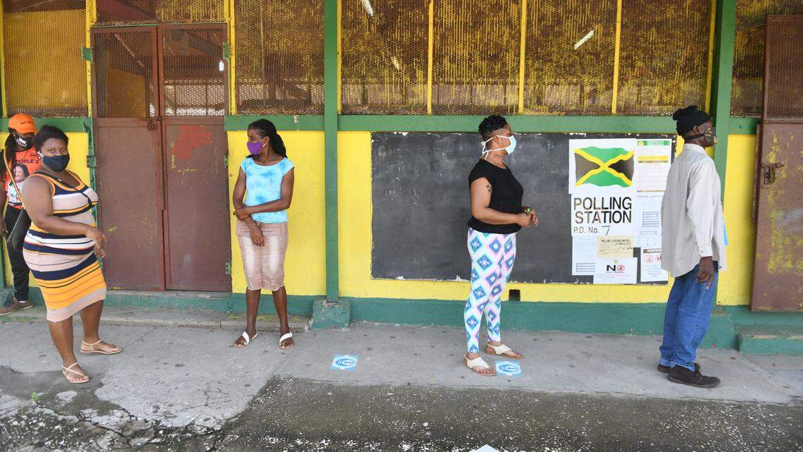 Voters adhering to the rules set out by the Electoral Office of Jamaica stand by the markers before they cast their ballot, at the Tolluch Primary school in the St. Catherine North Central constituency, during the contest between the People’s National Party (PNP) Natalie Neita and the Jamaica Labor Party’s Natalie Campbell Rodriques on election day, September 3, 2020.