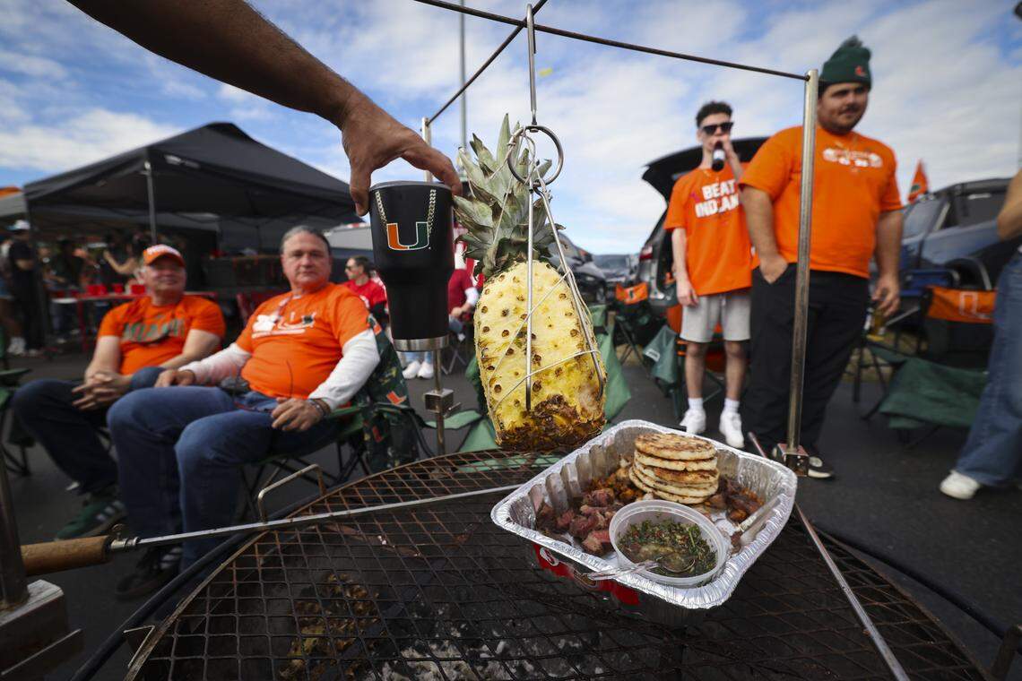 A pineapple sits on a grill at a tailgate outside the stadium before the College Football Playoff National Championship Game between the Miami Hurricanes and the Indiana Hoosiers at Hard Rock Stadium on Monday, Jan. 19, 2026 in Miami Gardens, Fla.