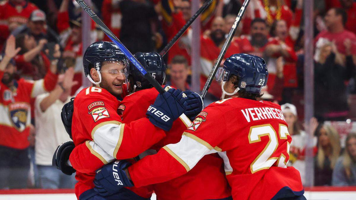 Florida Panthers centers Aleksander Barkov (16) and Carter Verhaeghe (23) hug defenseman Aaron Ekblad (5) after he scores a goal during the third period of Game 4 of the first-round Stanley Cup playoff series against the Tampa Bay Lightning on Monday, April 28, 2025, at Amerant Bank Arena in Sunrise, Fla. The Panthers won 4-2.