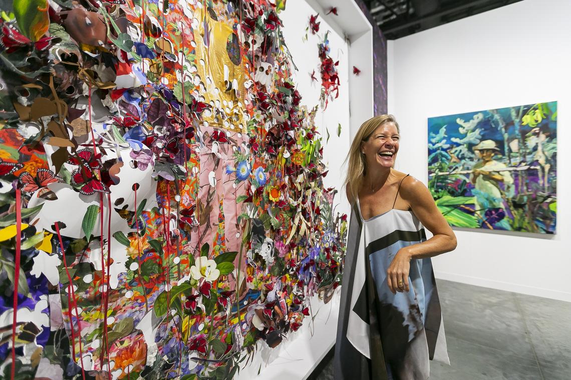 Kathryn Mikesell, co-founder and director of the Fountainhead Residency for artists in Miami, looks at a collage work by program alum and rising star Ebony G. Patterson during the Art Basel fair at the Miami Beach Convention Center.