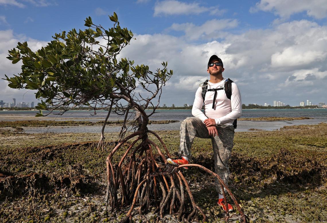 Andrew Otazo checks for garbage and discarded items in the mangroves and coral reef at Bear Cut during low tide. As of Tuesday, Jan. 23, 2019, Otazo, a Miami native, has removed 6,500 pounds of trash from Bear Cut Preserve over the past year. He wants to spread his message at the Miami Marathon, where he will carry 30 pounds of trash on his back for the entire 26.2 miles.