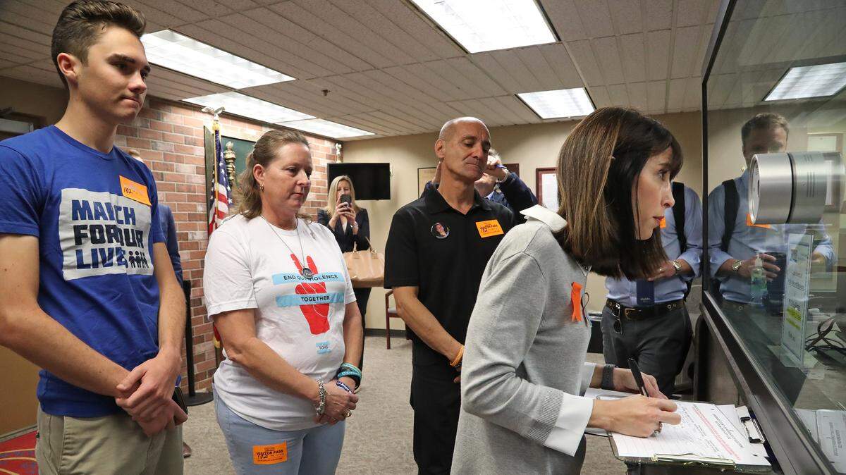 Ban Assault Weapons Now Chairwoman Gail Schwartz, aunt of Parkland shooting victim Alex Schachter, signs paperwork as she submits 200 petitions to the Broward County Supervisor of Elections office for review as part of a ballot initiative to put on the 2020 election ballot a ban on the sale of military-grade weapons. With Schwartz are, from left; Parkland shooting survivor David Hogg, Debbie Hixon, Parkland shooting victim Chris Hixon’s widow, and Mitch Dworet, Parkland shooting victim Nick Dworet’s father at the Broward County Government Center in Fort Lauderdale on Monday, Feb. 11, 2019.