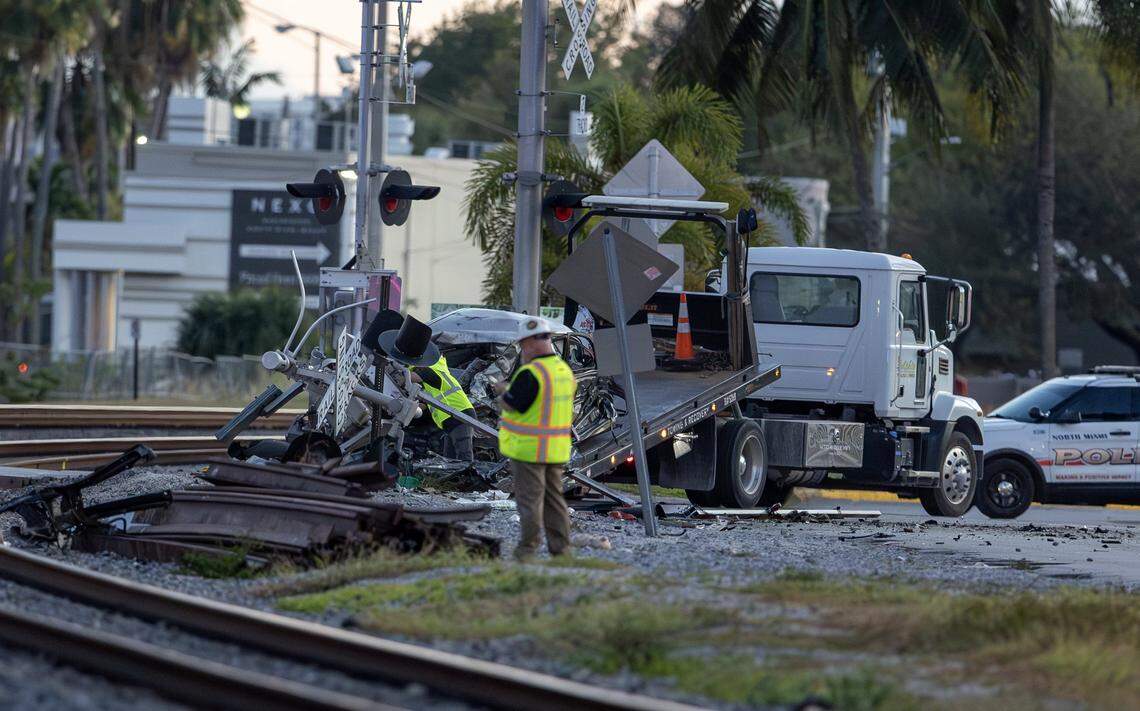 A vehicle involved in a collision with a Brightline train is seen on a towing truck as officials clear the area before it is removed near the 14100 block of Biscayne Boulevard in North Miami on Wednesday, Nov. 19, 2025. One person was airlifted to a trauma center.