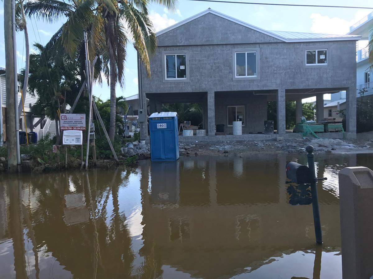 Water fills the street in front of a home under construction on Center Lane in the Key Largo subdivision of Stillwright Point on Tuesday, Oct. 15, 2019. The flooding started going down in early December after more than 90 days.