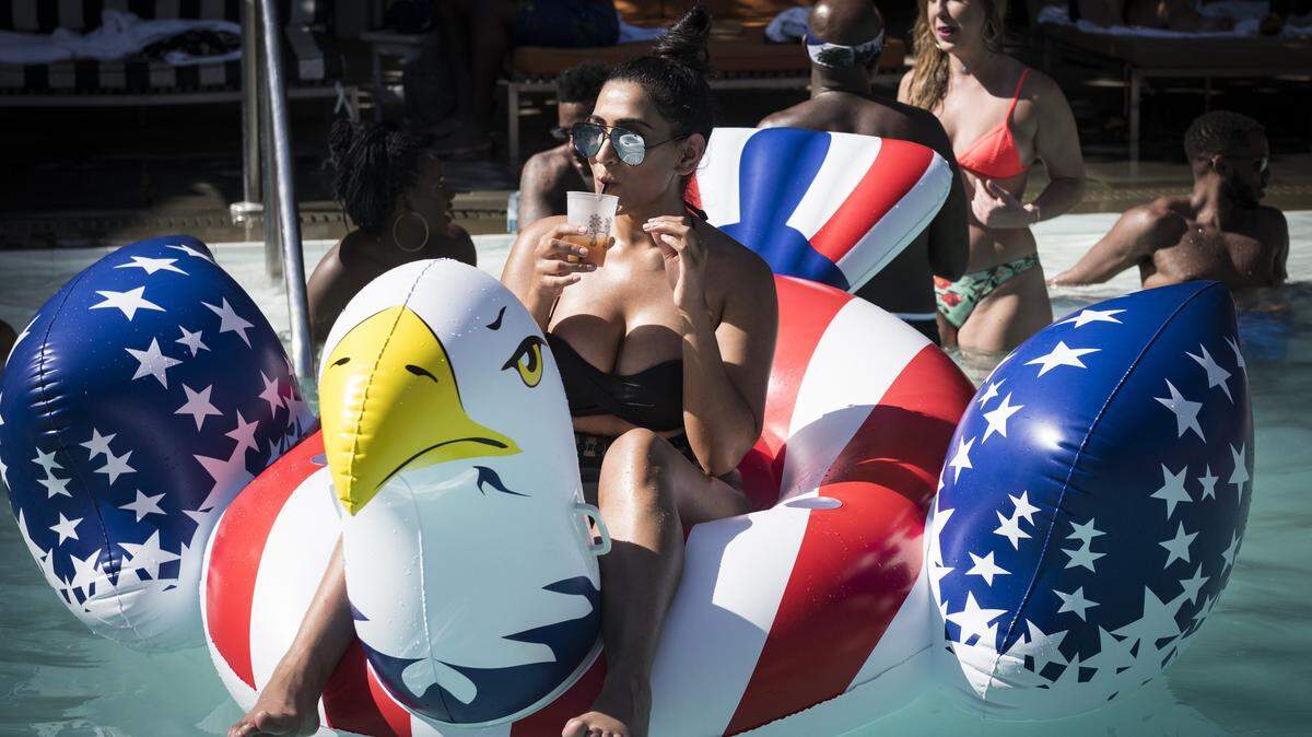 Durreshuah Khokhar enjoys her drink while she sits on top of the 4th of July pool float during the pre-Fourth of July pool party at SLS South Beach Hyde Beach on Mon., July 3, 2017.