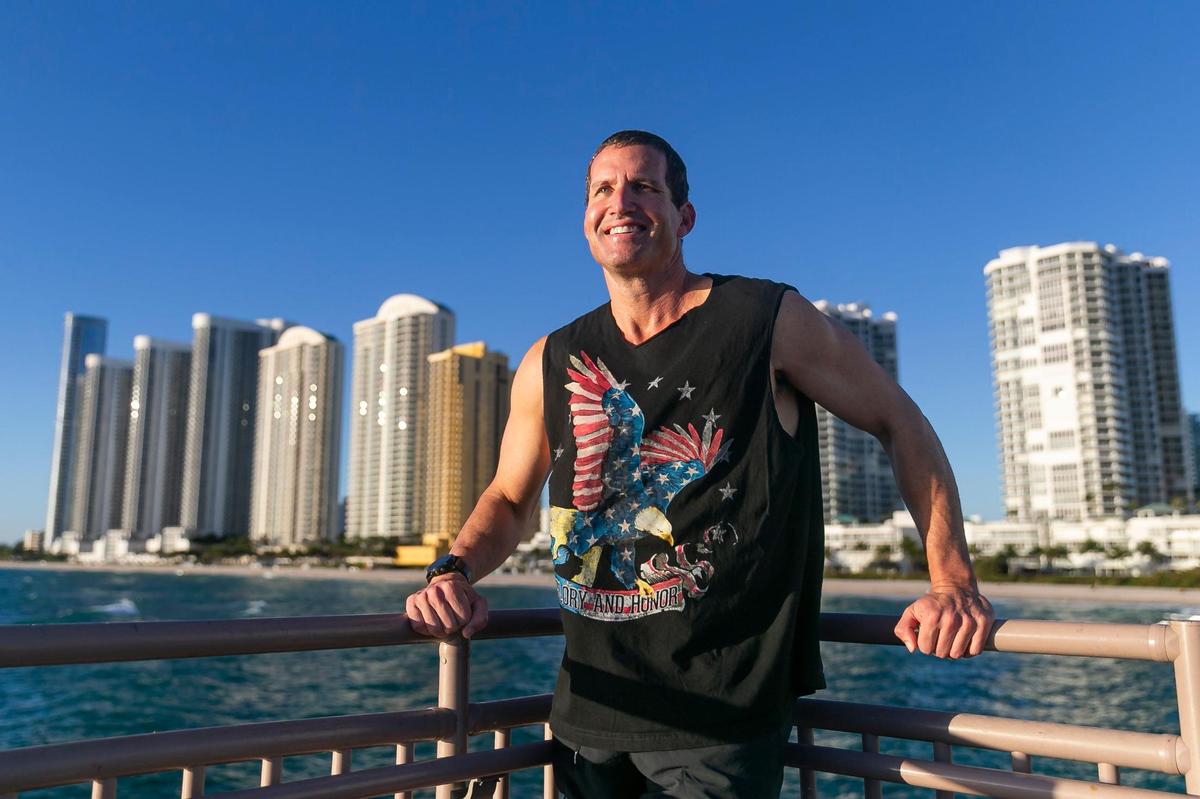 Mika Shevit, 48, who will be running in the half-marathon portion of this year’s Miami Marathon, is photographed at the Newport Fishing Pier on Thursday, Jan. 19, 2023 in Sunny Isles Beach, Fla. Shevit has been running a half marathon for more than 650 days consecutively and is looking to reach at least a 1000-day streak.