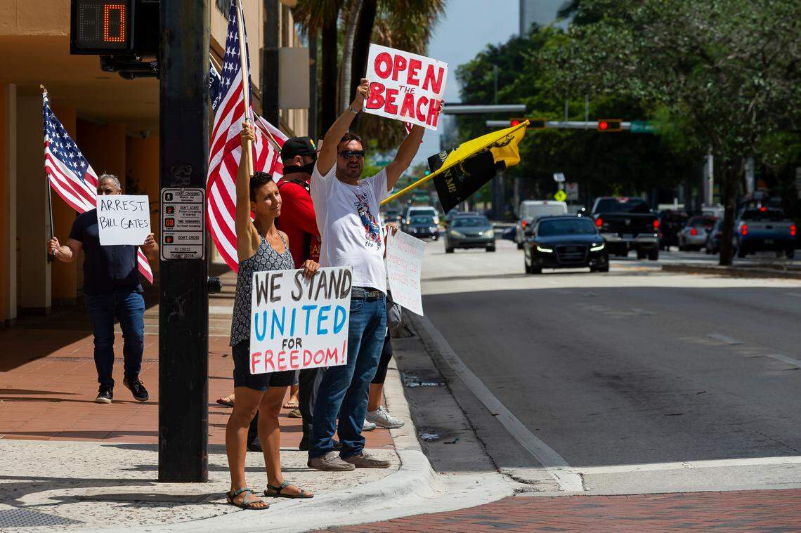 Protestors with the Reopen South Florida Group host a demonstration outside of the Broward County Governmental Center during a commission meeting on Tuesday, May 19, 2020. Commission meetings are currently closed to the public due to the coronavirus restrictions officials have put into place.