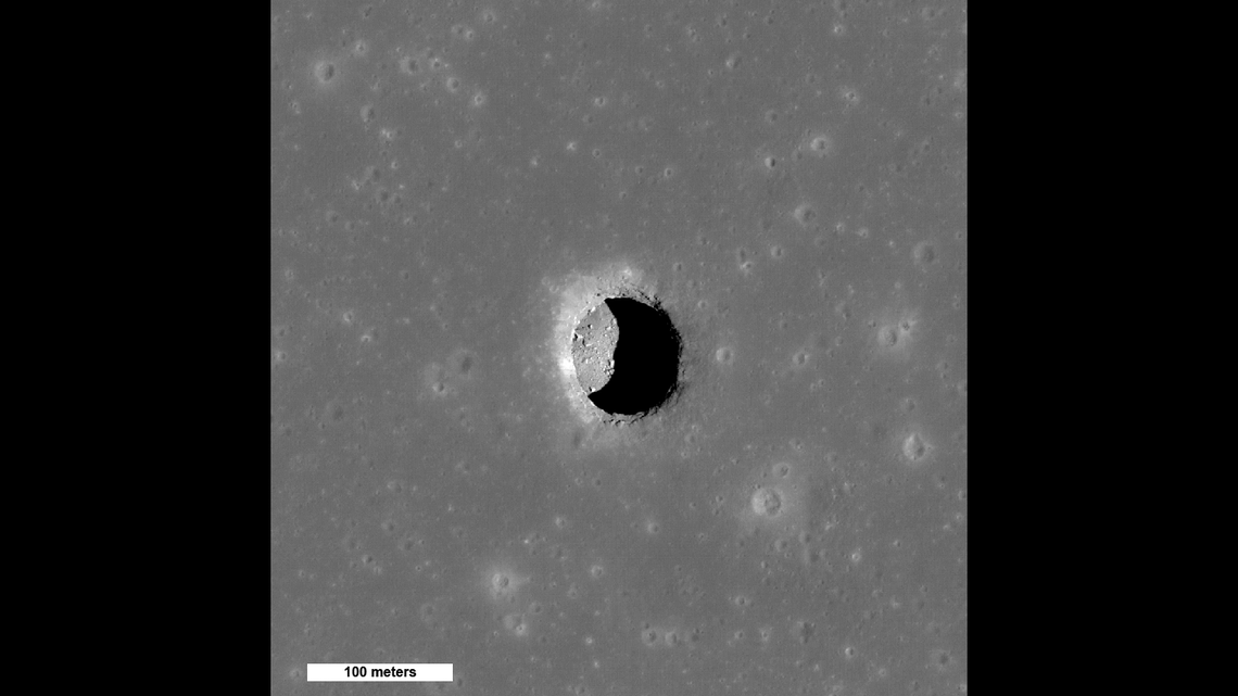 This is a view of the Mare Tranquillitatis pit crater, showing “boulders on an otherwise smooth floor.” It could be a cave entrance.