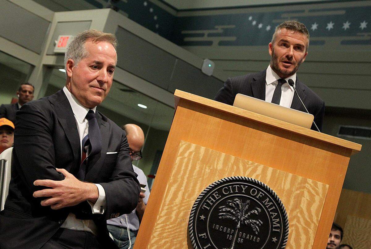 Jorge Mas, Chairman of the Board for MasTec, listens as his partner David Beckham speaks at a public hearing on the possibility of bringing a Major League Soccer stadium - MLS Expansion to Miami at Miami City Hall on July 12, 2018. In November, Miami voters gave commissioners the go-ahead to begin negotiating an exclusive stadium lease with the Beckham group.