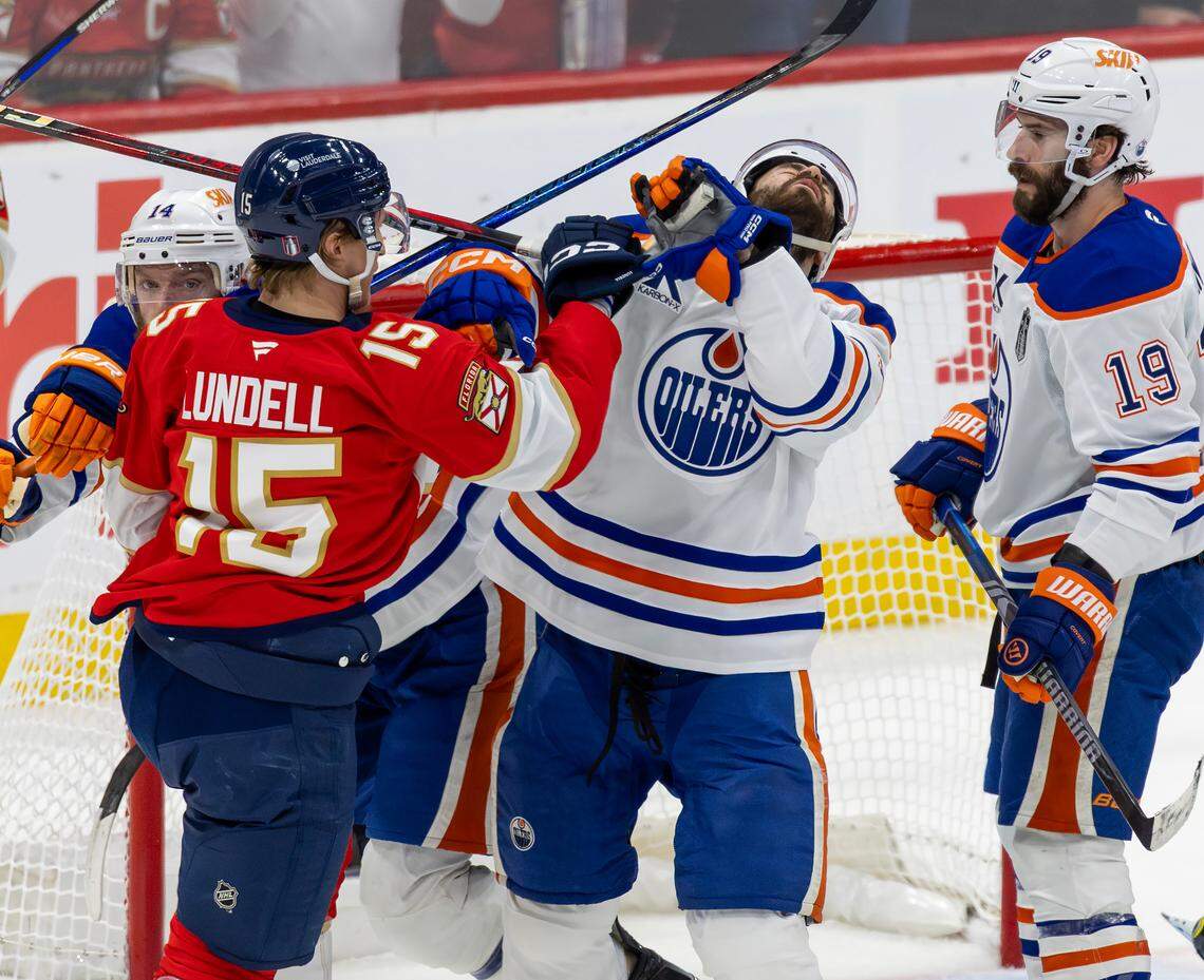 Florida Panthers center Anton Lundell (15) and Edmonton Oilers defenseman Evan Bouchard (2) exchange punches during the first period of Game 3 in the NHL Stanley Cup Final at Amerant Bank Arena on Monday, June 9, 2025, in Sunrise, Fla.