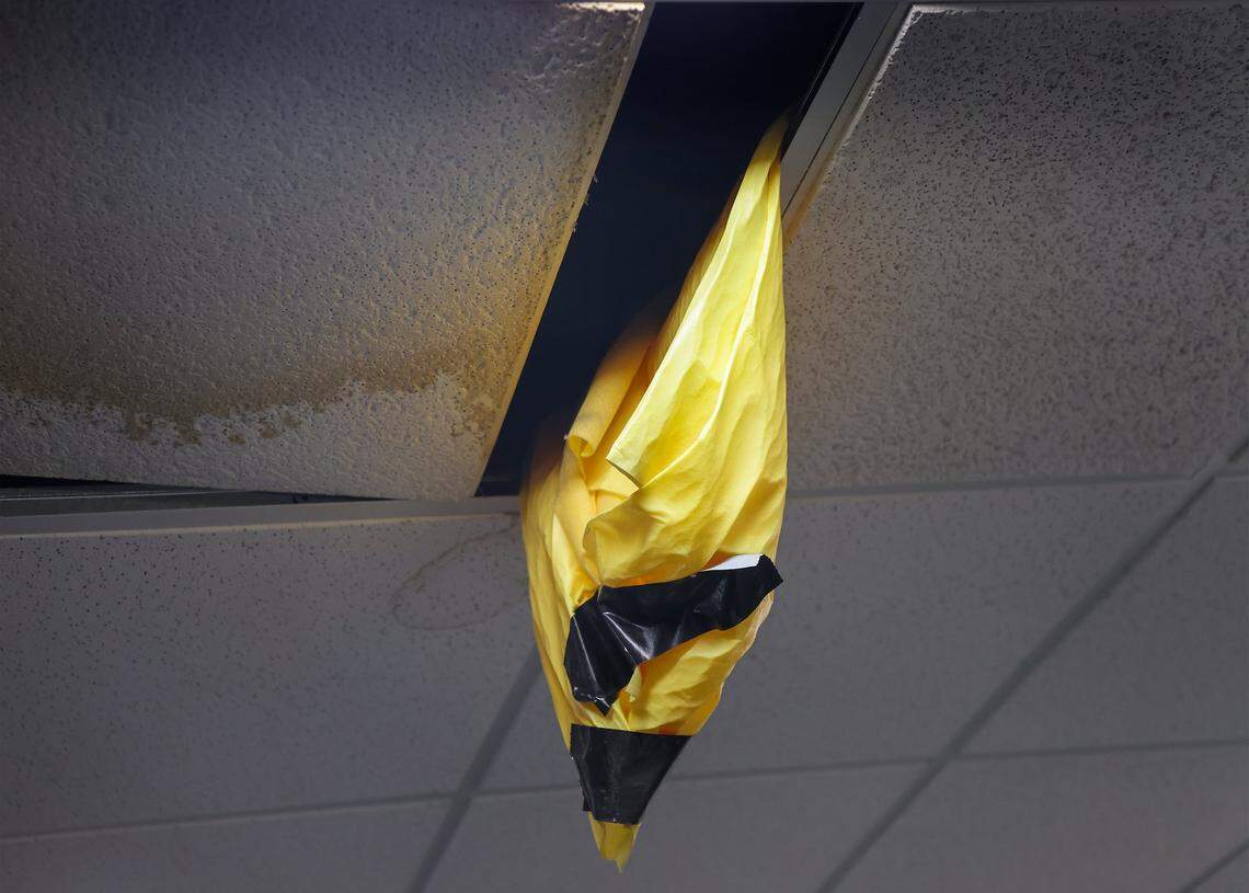 A yellow bag is placed above a large trash bend to funnel the water pouring from the ceiling in the Homicide Unit of the Miami Police Department Headquarters. Miami Mayor Eileen Higgins toured the city's police and fire facilities in Miami, Florida on Monday, April 20, 2026. Higgins is proposing a general obligation bond to fund critical repairs and upgrades to aging public safety buildings, citing concerns over deteriorating conditions that threaten effective emergency response and community safety.