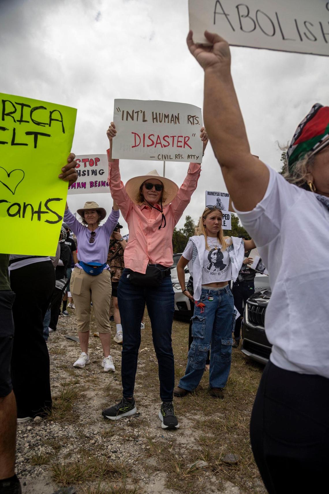 Kristin Ziv, center, who currently lives in Colorado, was in town visiting her sister former Miami Dade County Commissioner Katy Sorenson when she read about the plans for the protest against conditions inside the Krome Detention Center so she decided to join her sister, left, at the protest outside the Krome Detention Center.