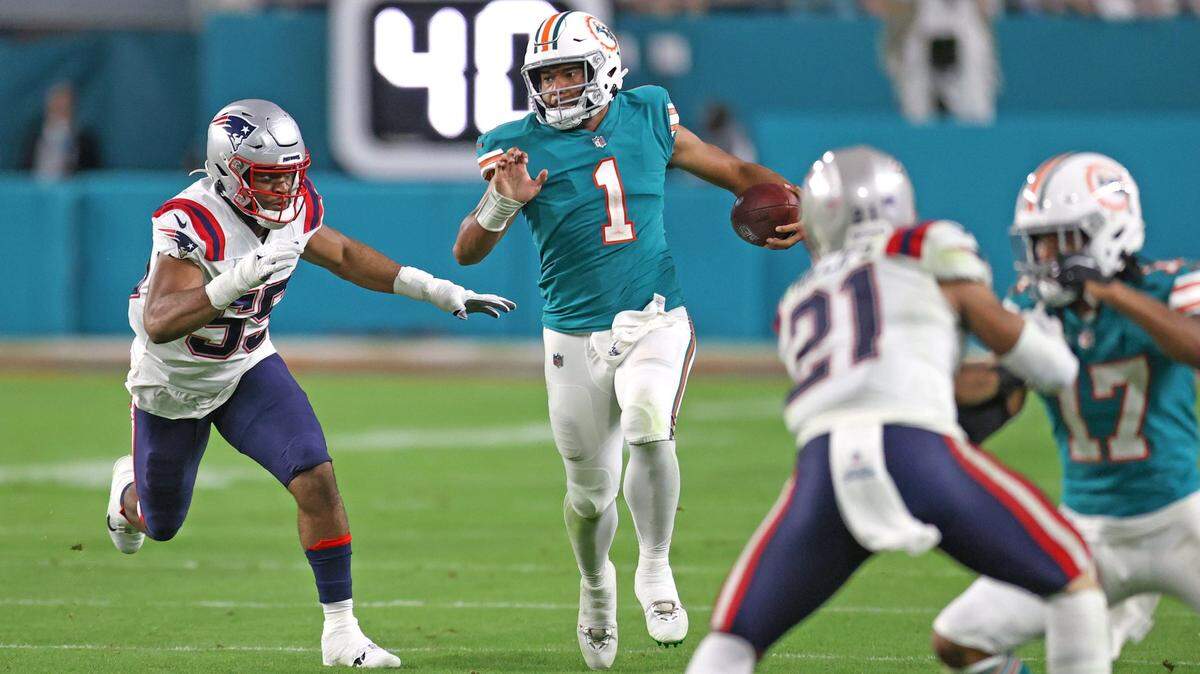 Miami Dolphins quarterback Tua Tagovailoa (1) runs for a runs for a first down during the fourth quarter of an NFL football game against the New England Patriots at Hard Rock Stadium on Sunday, January 9, 2022 in Miami Gardens, Florida. (David Santiago Photo / Miami Herald)