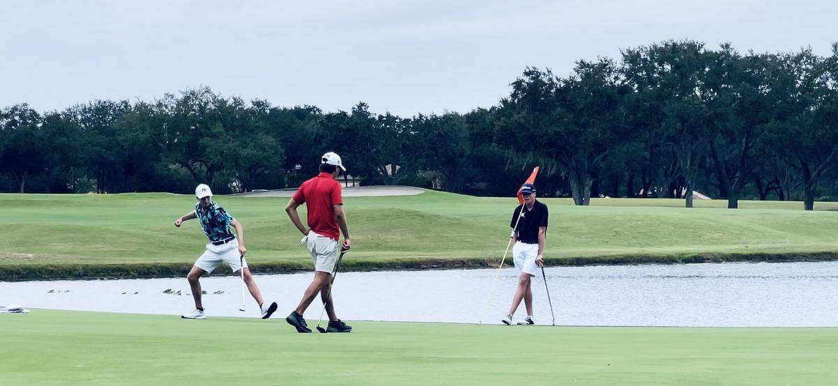 Pine Crest golfer Alexander Weinberg (left) winds up to pump his fist in celebration after sinking a birdie putt on the 18th hole and clinching the Class 1A individual state championship on Wednesday at Howey-in-the-Hills, Fla.