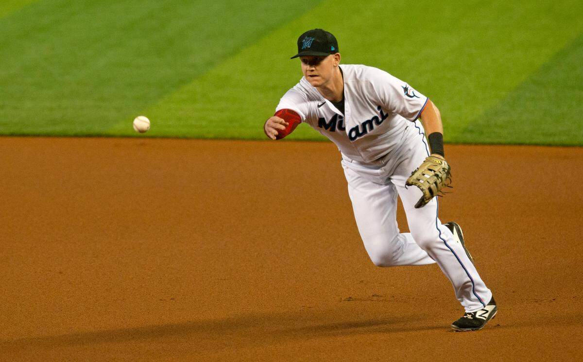 Miami Marlins first baseman Garrett Cooper (26) throws to first to put out Boston Red Sox center fielder Alex Verdugo (99) during the first inning of a baseball game against the Boston Red Sox at at Marlins Park in Miami on Wednesday, September 16, 2020.