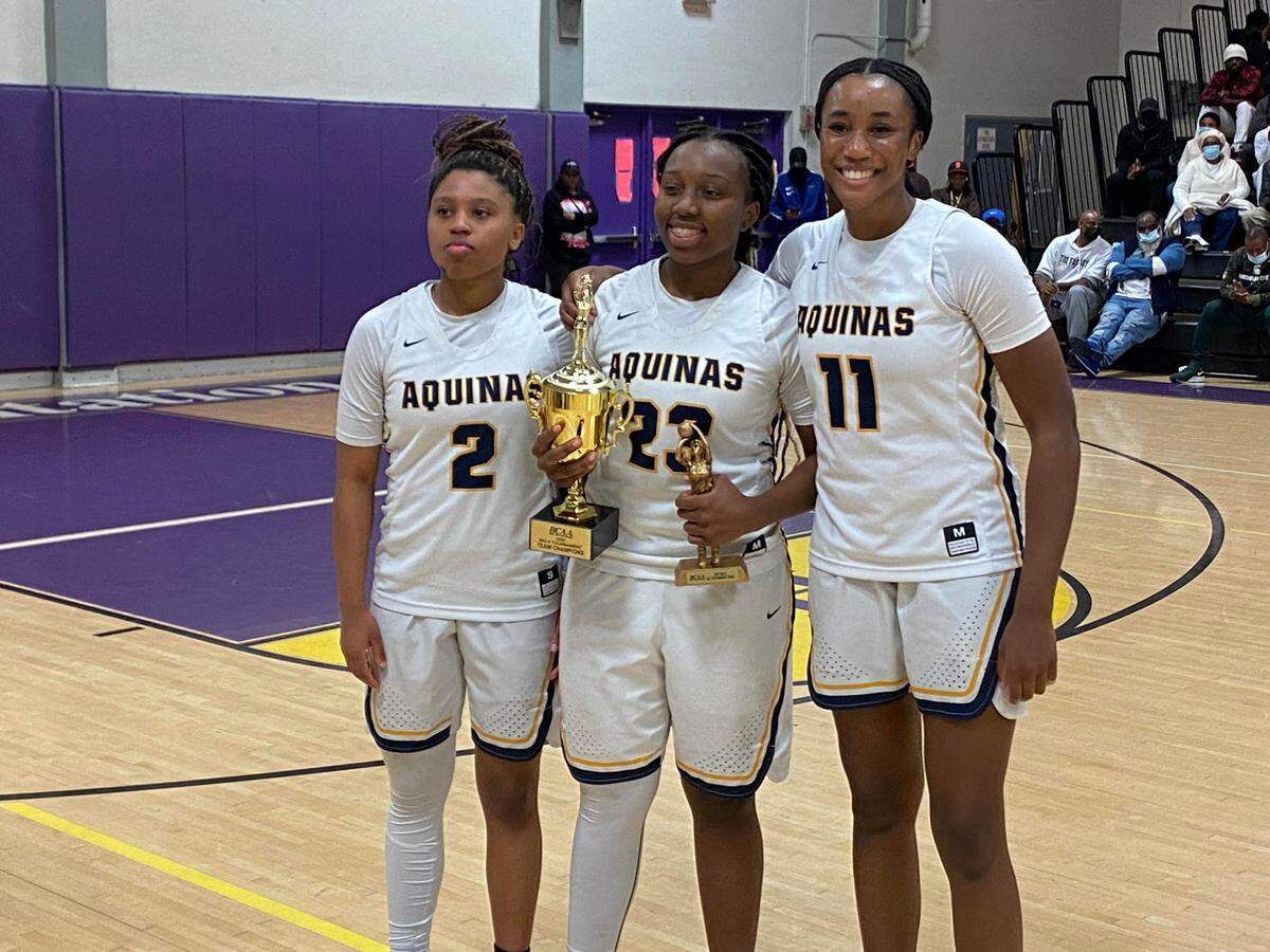 Maya Williams, Alancia Ramsey and Jada Green celebrate after St. Thomas Aquinas’ 65-51 victory over Dillard on Saturday night at South Plantation High, which clinched their first BCAA Big 8 tournament championship.
