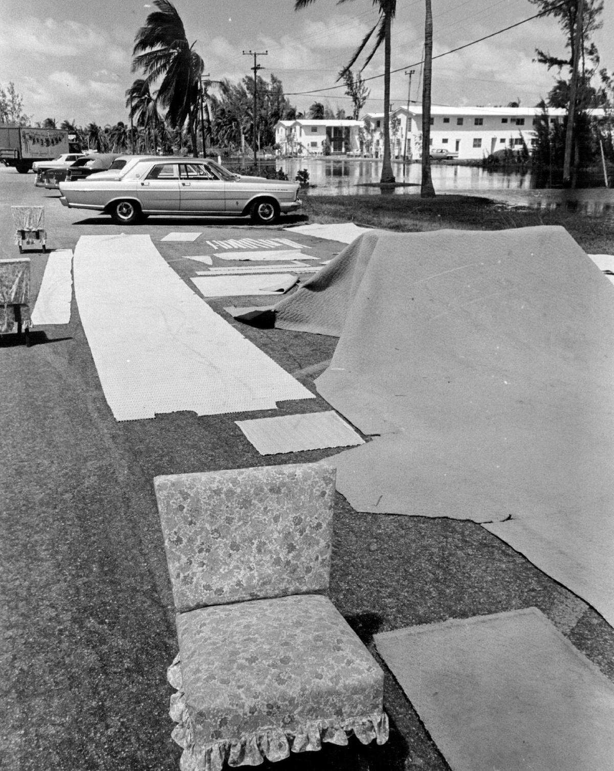 Rugs and furniture are spread out to dry at a Key Biscayne shopping center after being soaked by the churning water from Hurricane Betsy.