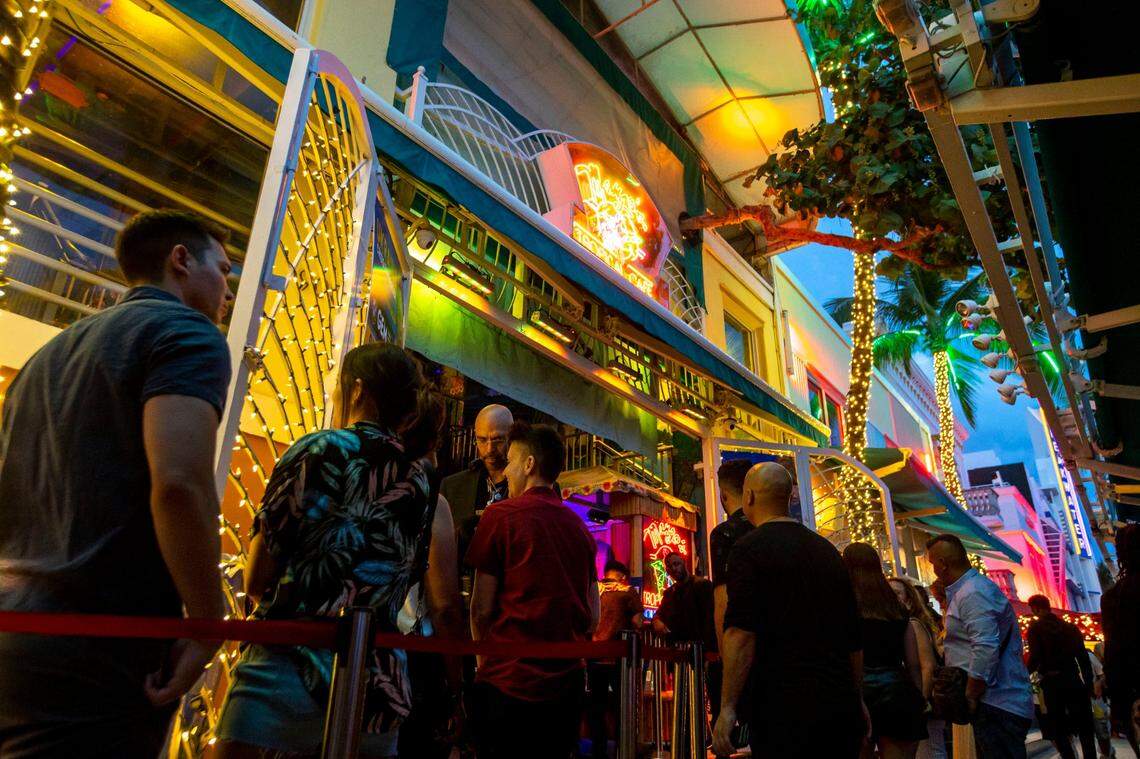 People wait in line to have their identifications checked by a bouncer at Mango’s Tropical Cafe South Beach, on Ocean Drive, during Memorial Day weekend in Miami Beach, Florida, on Saturday, May 28, 2022.