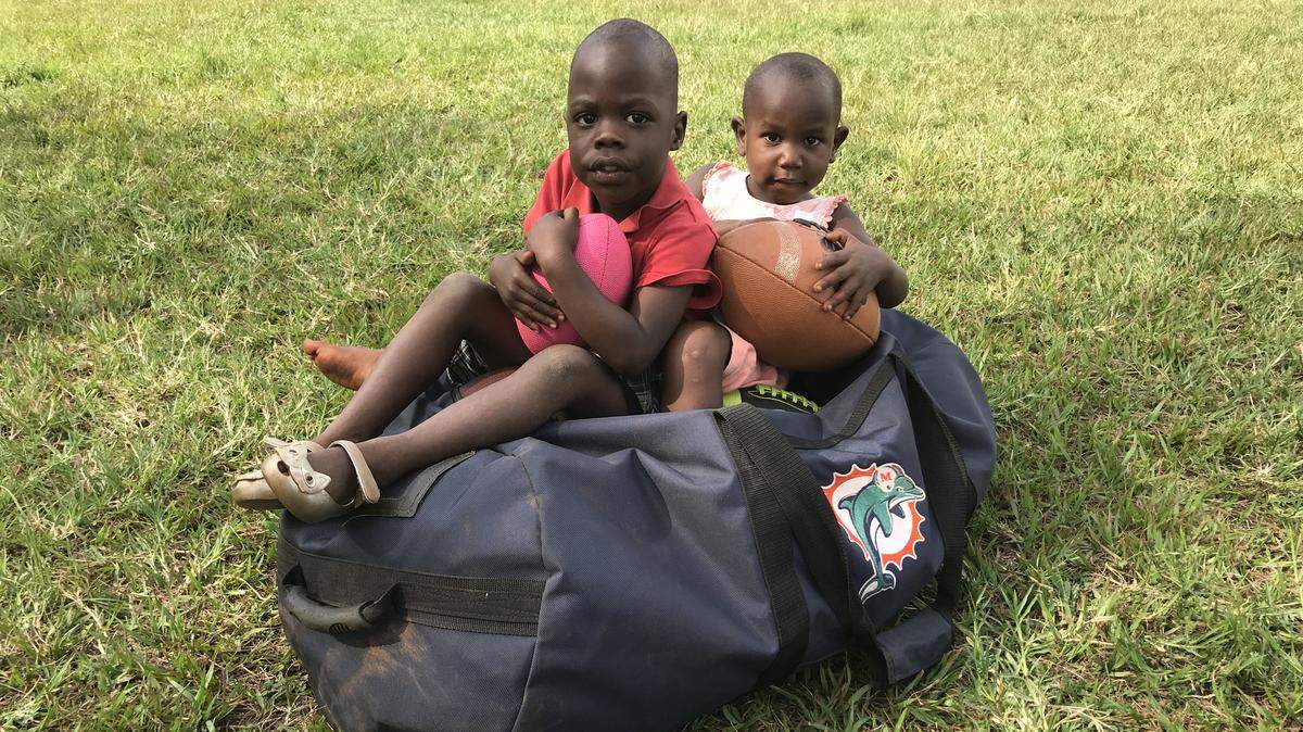 In a small part of a largely forgotten part of the world, there are Dolphins fans, thanks to offensive line coach Jeremiah Washburn, who travels to Uganda every summer to teach orphans the game of football.