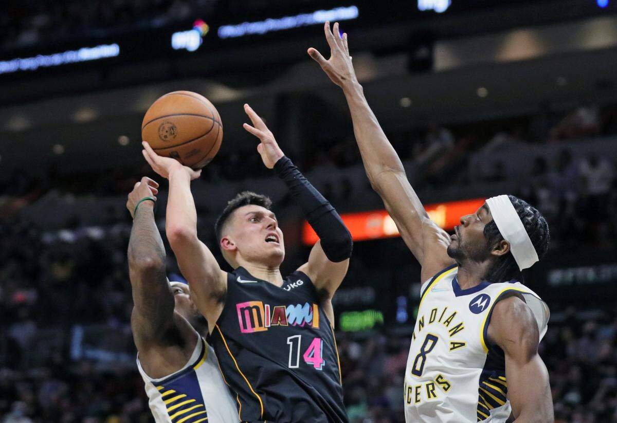 Miami Heat guard Tyler Herro attempts a basket as Indiana Pacers forward Justin Holiday defends at the FTX Arena in Miami on Tuesday, Dec. 21, 2021.