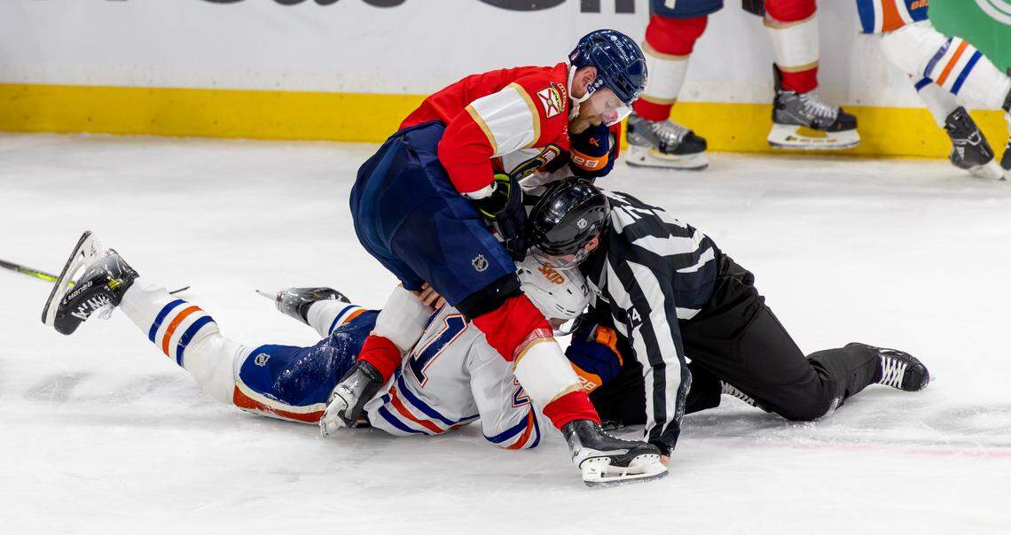 NHL linesman Trent Knorr (74) tries to break up a fight between Florida Panthers center Sam Bennett (9) and Edmonton Oilers center Trent Frederic (21) during the third period of Game 3 in the Stanley Cup Final at Amerant Bank Arena on Monday, June 9, 2025, in Sunrise, Fla.