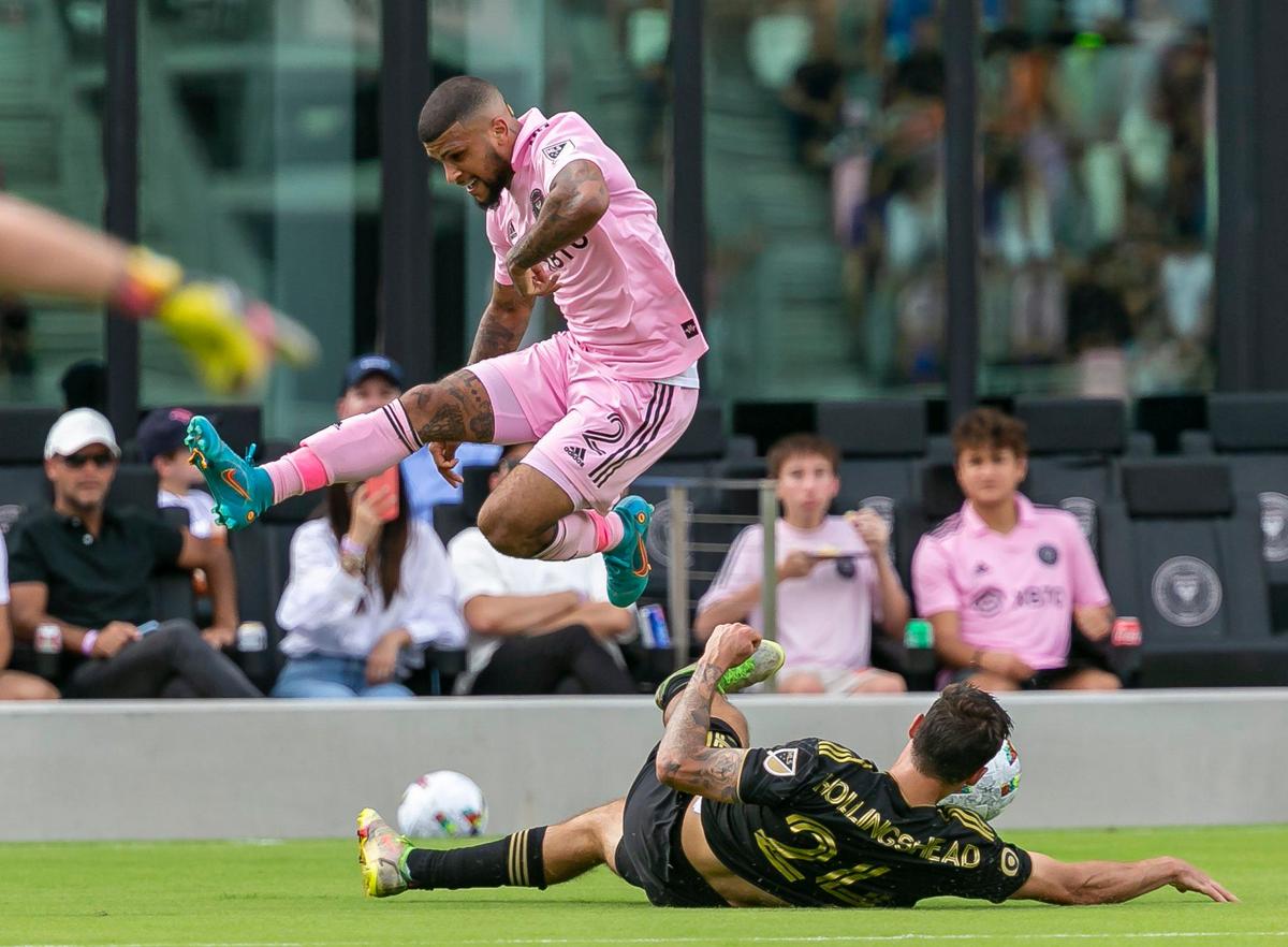 Inter Miami defender DeAndre Yedlin (2) jumps over Los Angeles FC midfielder Ryan Hollingshead (24) during the first half of their MLS soccer match at DRV PNK Stadium on Saturday, March 12, 2022, in Fort Lauderdale, Florida.