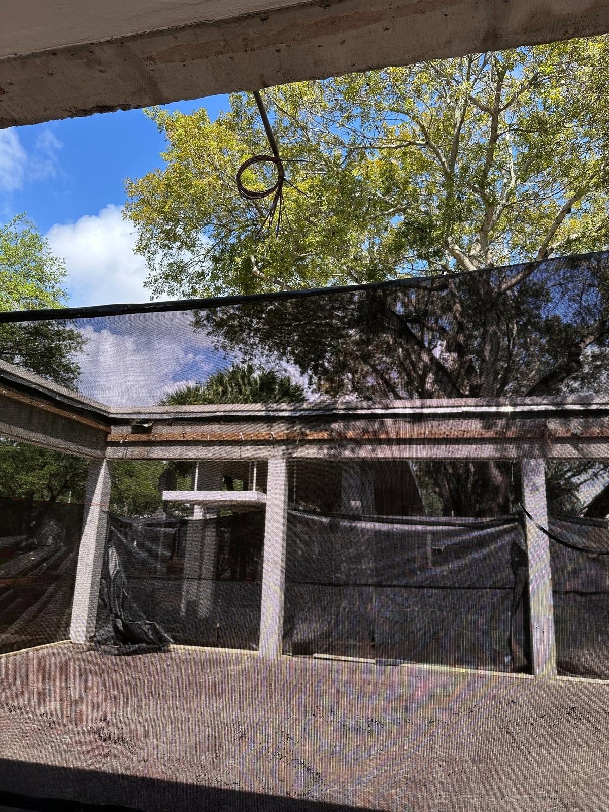 A mesh screen covers the partially collapsed patio roof Monday, March 31, 2025, at the Mahoney-Pearson freshman dorm complex at the University of Miami in Coral Gables. The Sunday evening collapse was due to heavy rains.