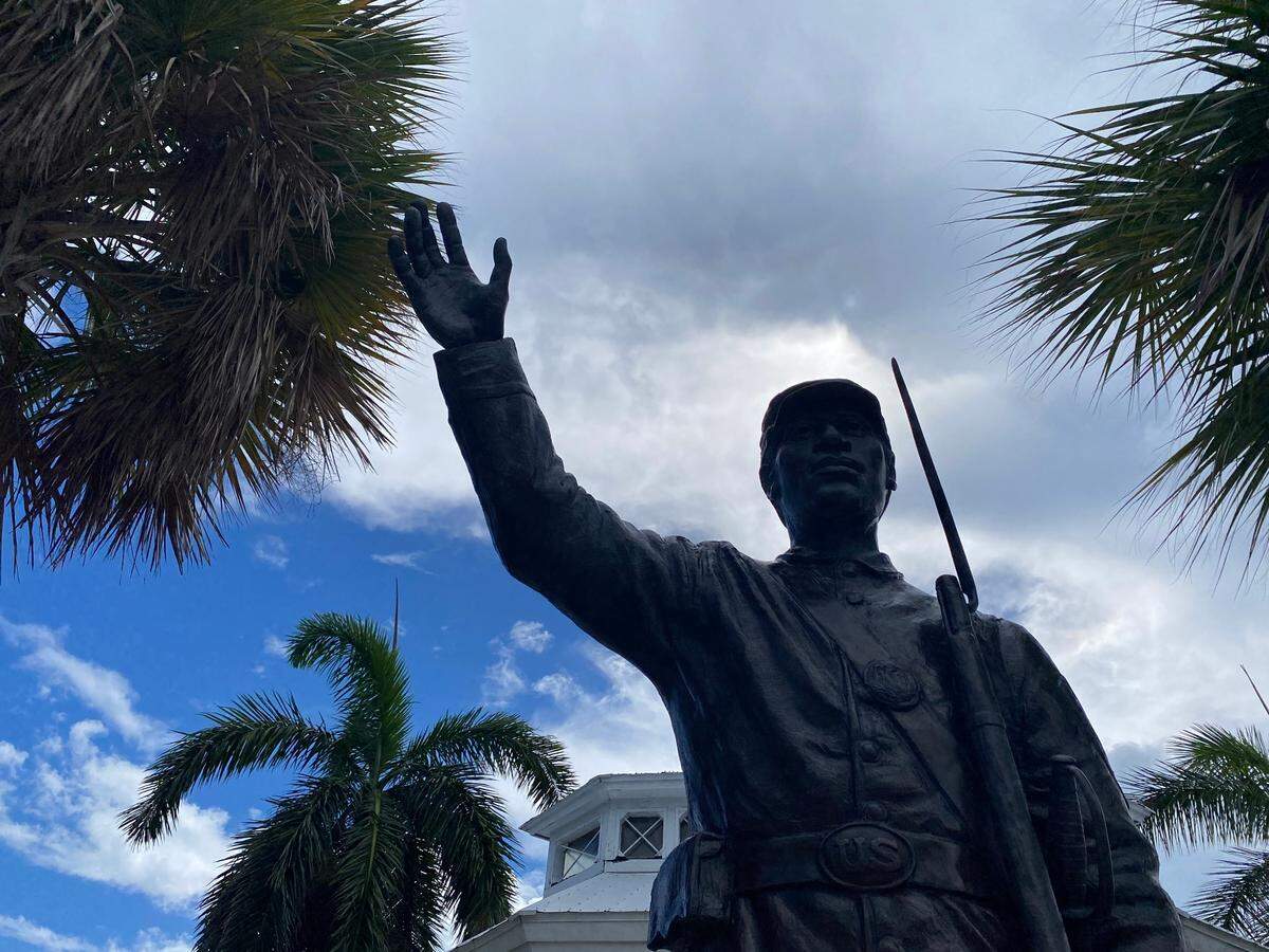 Next to a memorial that honors fallen Confederate soldiers in Key West, a statue of a Black Union soldier stands.
