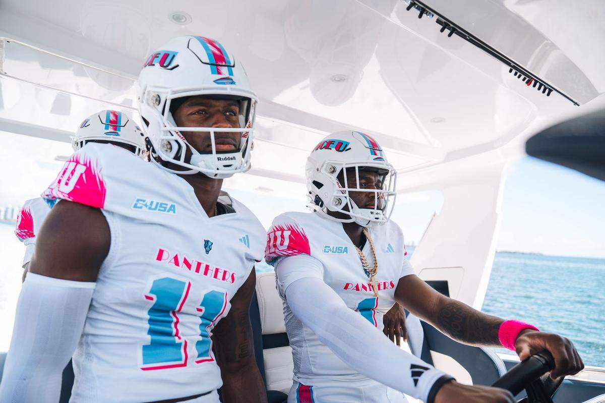 FIU quarterback Keyone Jenkins (1) and receiver Dean Patterson (11) wear their new “Vice U” uniforms, which the Panthers are set to debut on Tuesday, Oct. 22 when they play Sam Houston State at Pitbull Stadium.