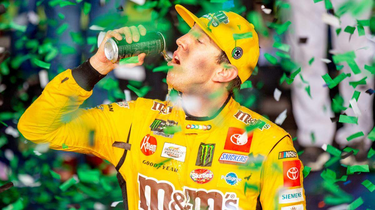 Kyle Busch (18) takes a swig from a Monster energy drink after winning the Homestead-Miami Speedway NASCAR 21st Annual Ford EcoBoost 400 Monster Energy Series in Homestead, Florida on Sunday, Nov. 17, 2019.