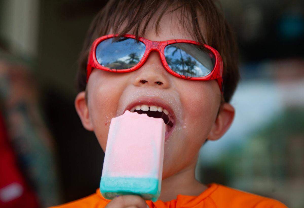 Christopher Corea, 4, eats a popsicle from South Pointe Cafe at South Pointe Park before playing in the splash pad on Wednesday, July 5, 2023 in Miami Beach, Fla.