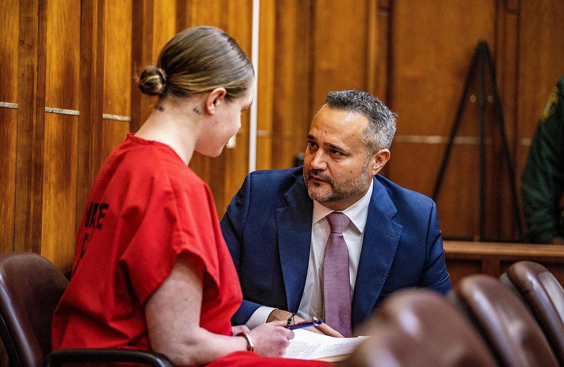 OnlyFans model Courtney Clenney talks to her lawyer Frank Prieto during a detention hearing Tuesday in her murder case.