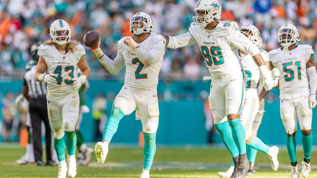 Miami Dolphins linebacker Bradley Chubb (2) celebrates with defensive tackle Raekwon Davis (98) after strip sacking New York Jets quarterback Trevor Siemian (14) in the fourth quarter of an NFL game at Hard Rock Stadium on Sunday, Dec. 17, 2023, in Miami Gardens, Fla.